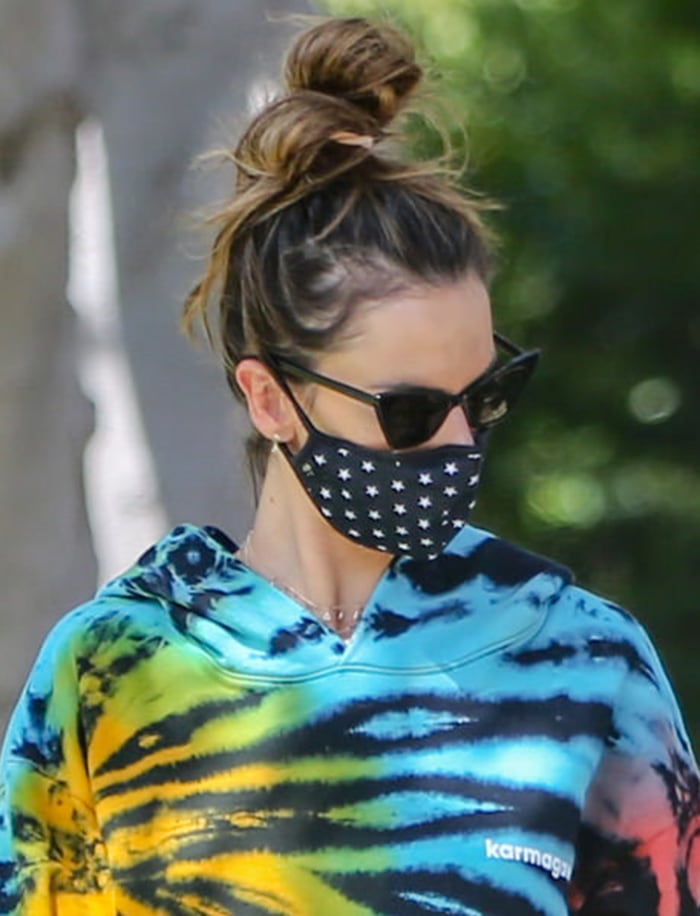 Alessandra Ambrosio wears cat-eye sunglasses and a star-print face mask