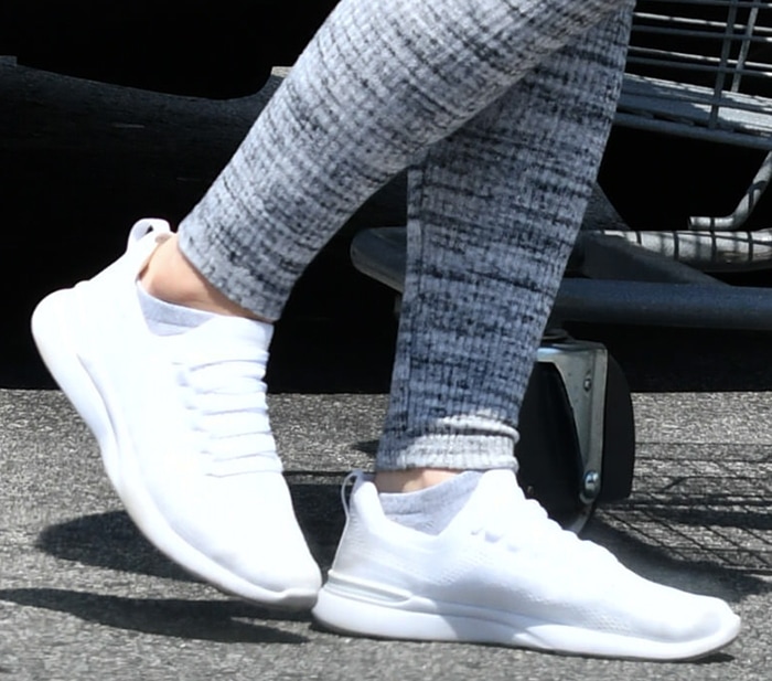 A close-up reveals the sleek, sock-like construction of Ariel Winter’s APL TechLoom Breeze sneakers, where the seamless upper and low-profile Propelium sole deliver a barely-there feel with modern performance-driven design