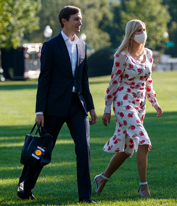 Ivanka Trump crosses the South Lawn in Altuzarra's red poppy-print Livia dress, pairing the romantic silhouette with white Gianvito Rossi Portofino sandals and a coordinated embroidered face mask