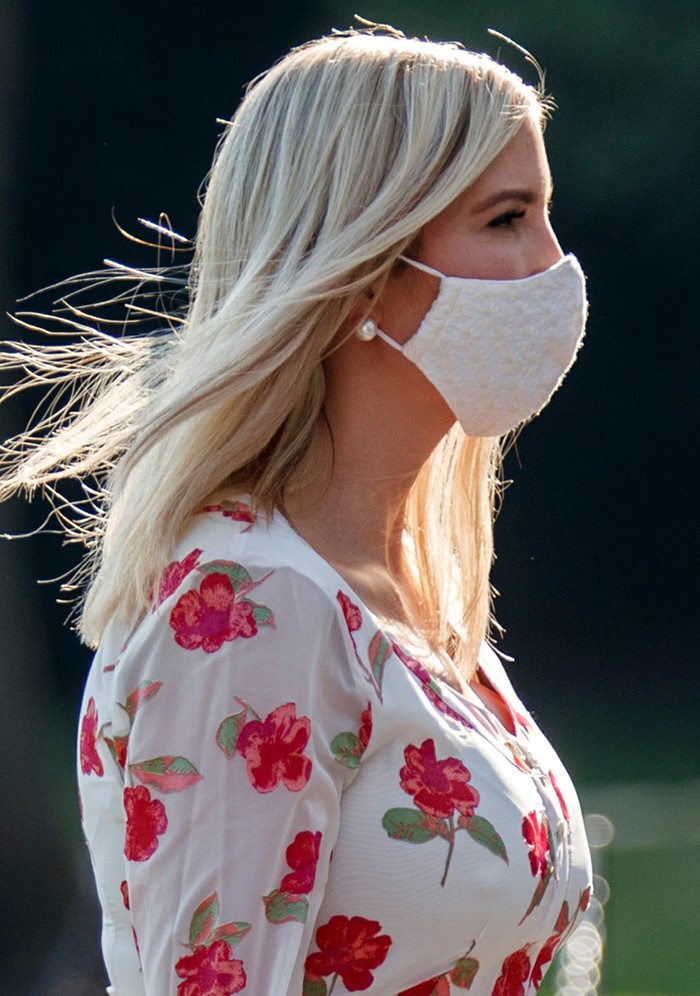Pearl earrings, wind-swept blonde hair, and an embroidered white face mask complemented Ivanka Trump's floral Altuzarra dress during her July 2020 White House appearance