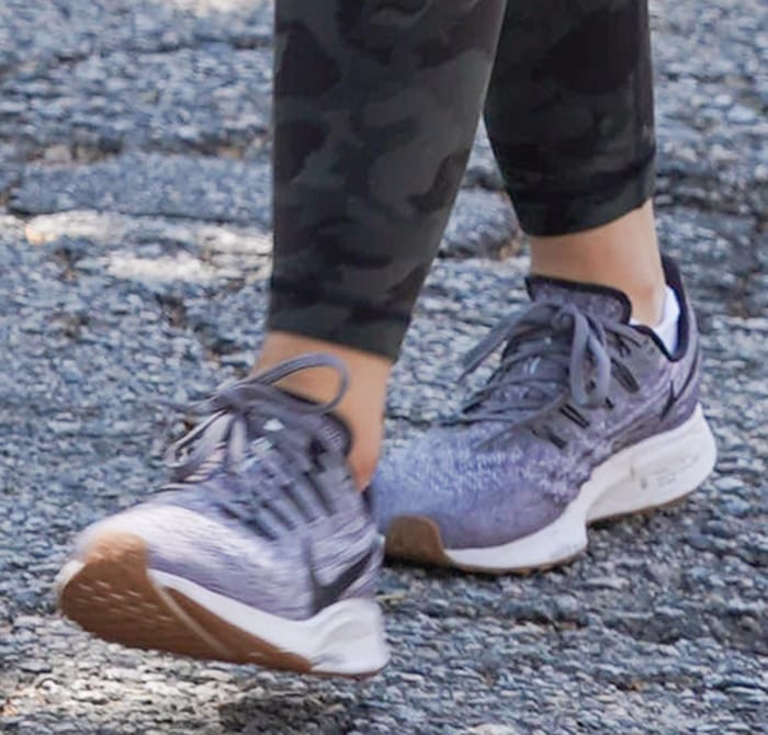 Lucy Hale steps out in Gunsmoke Nike Air Zoom Pegasus 36 sneakers, pairing the lightweight trainers with camo leggings for a functional yet polished athleisure look