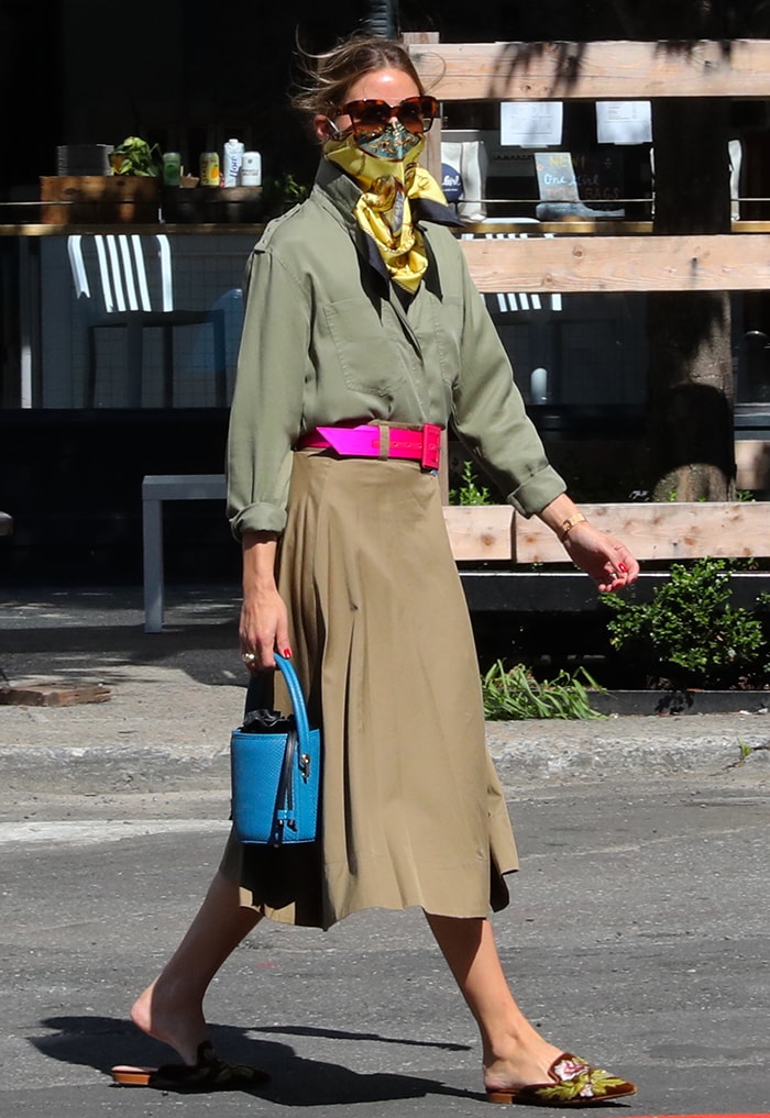 Olivia Palermo wears an olive Zara shirt and brown midi skirt in Dumbo, Brooklyn