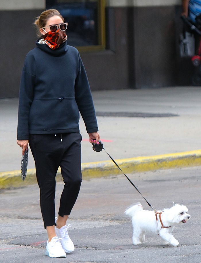 Olivia Palermo walks Mr. Butler in Downtown Brooklyn wearing black athleisure and white Nike Air Max 270 sneakers