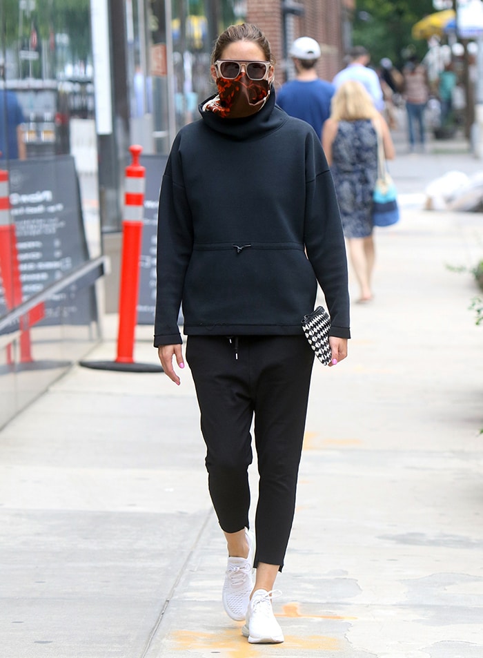 Olivia Palermo pairs a black hoodie and cropped sweatpants with white Nike Air Max 270 sneakers