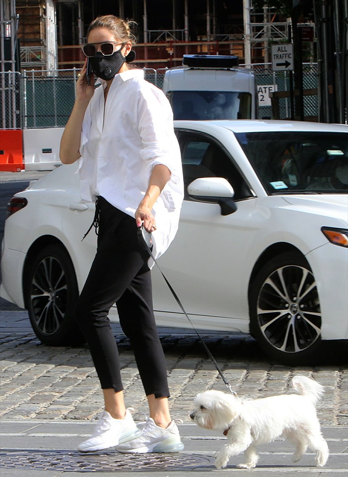 Olivia Palermo walks Mr. Butler in Downtown Brooklyn on July 28, 2020, pairing an oversized white shirt and black joggers with white Nike Air Max 270 sneakers