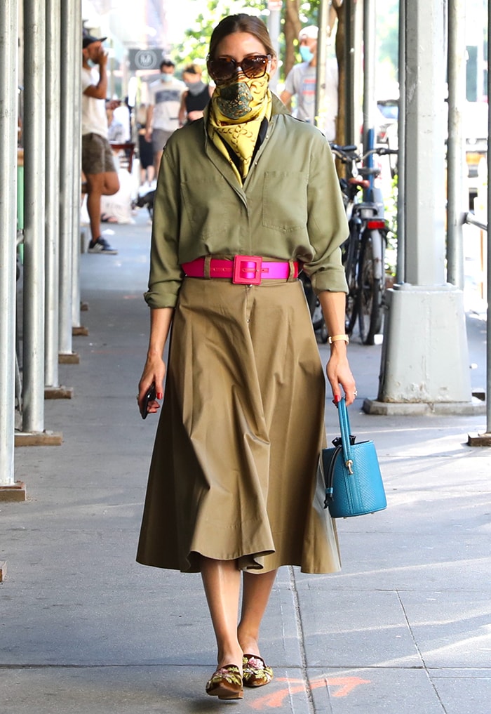 Olivia Palermo wears an olive shirt, brown midi skirt, hot-pink belt, yellow scarf, and Alberta Ferretti mules