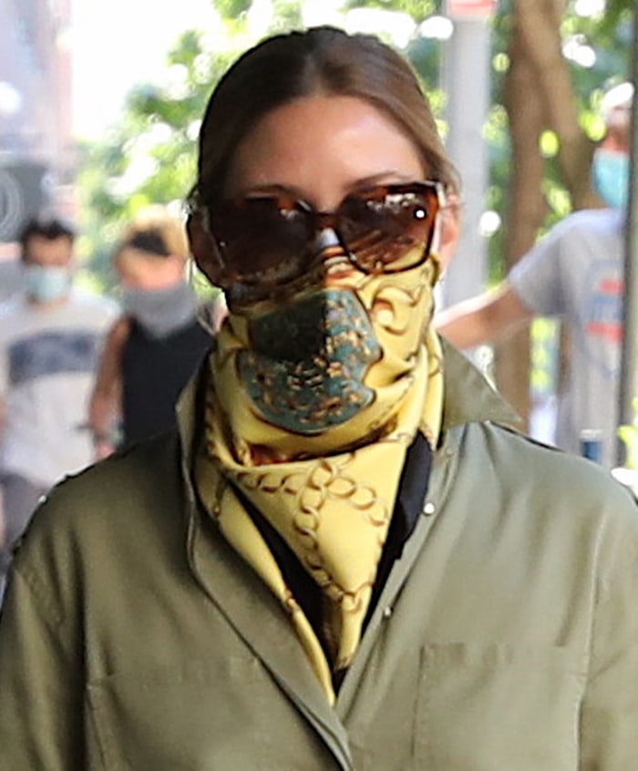 Olivia Palermo brings brighter color into the earth-tone outfit with a yellow silk scarf