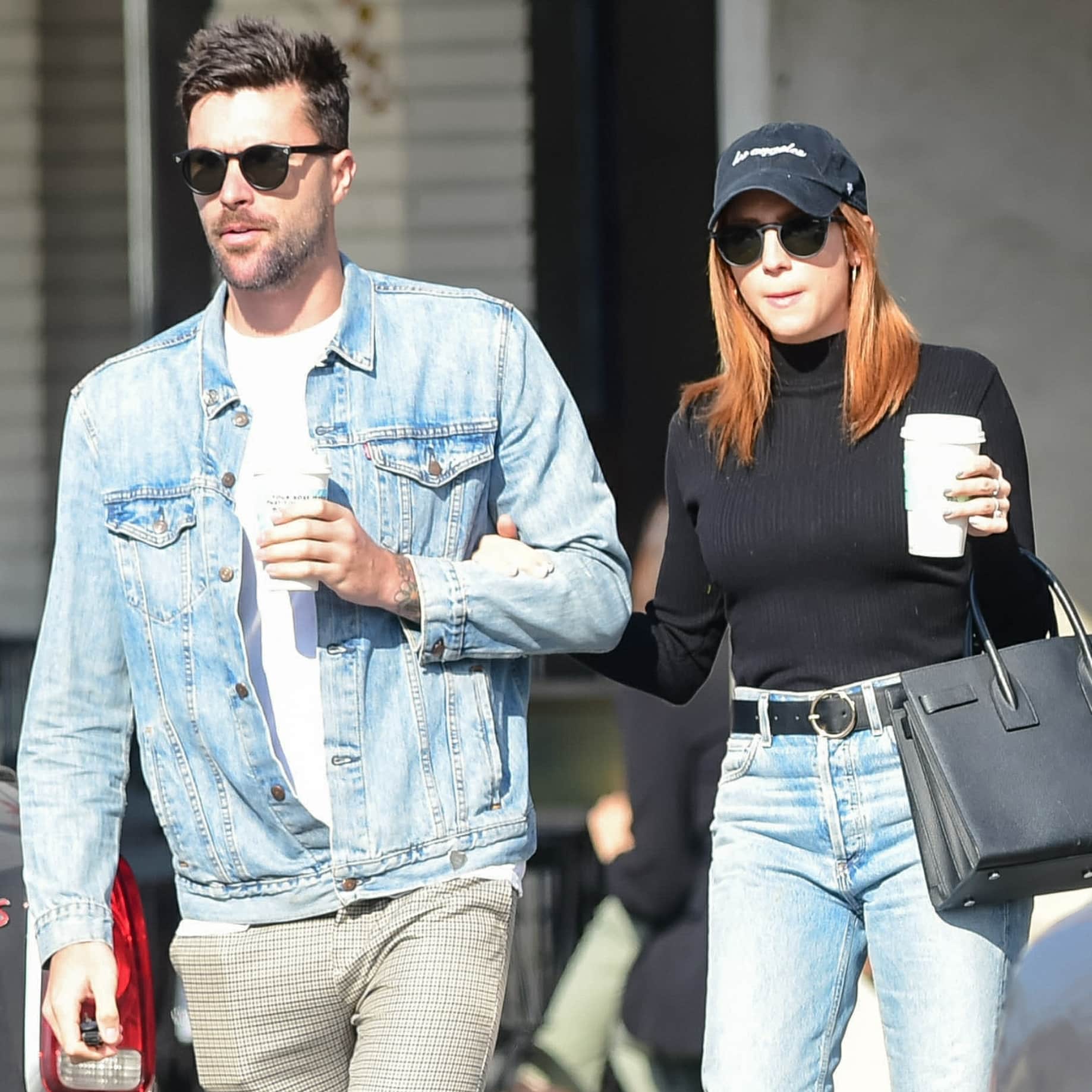 Tyler Stanaland and Brittany Snow keep it effortlessly chic in coordinated casual looks—Tyler in a denim jacket and Brittany in a sleek black turtleneck with classic jeans