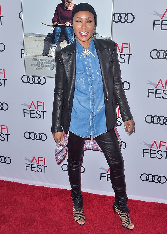 Jada Pinkett Smith rocks a casual-chic look with a denim shirt layered under a leather jacket, paired with leather pants and strappy heels at AFI Fest