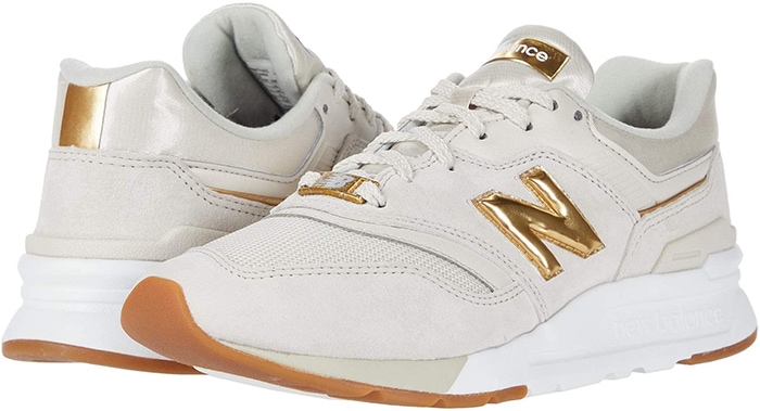 The moonbeam-and-gold New Balance 997H sneakers combine retro running-shoe design with suede overlays, breathable mesh panels, reflective metallic branding, and cushioned midsoles built for everyday comfort