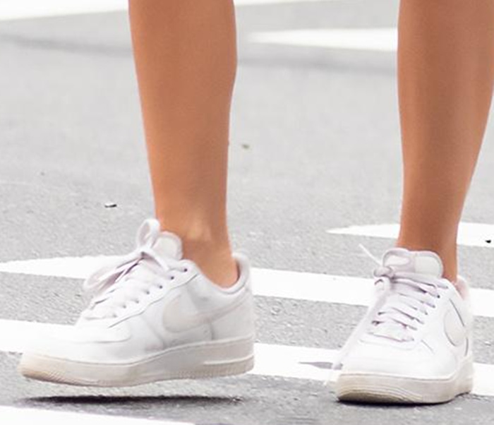 Emily Ratajkowski finished her oversized sweater and biker shorts with crisp white Nike Air Force 1 sneakers, a timeless silhouette that balanced the relaxed off-duty look