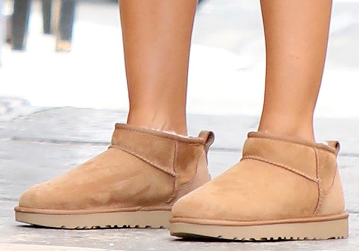 Emily Ratajkowski softened her sporty athleisure layers with chestnut UGG Classic Ultra Mini boots, the ankle-height silhouette that helped spark UGG's 2020s revival