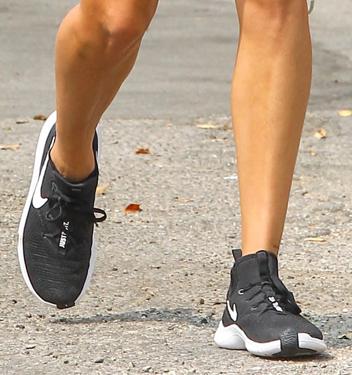 Hailey Bieber finished her relaxed athleisure look with black-and-white Nike TR8 training shoes, a lightweight workout style that reflected the practical sneaker trend dominating off-duty celebrity fashion in 2020