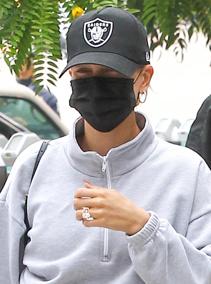 An Akings First Aid face mask, New Era Raiders 9Twenty hat, and Anita Ko gold braided hoop earrings added subtle personality to Bieber's otherwise understated workout-to-lunch ensemble