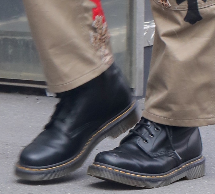 The iconic Dr. Martens 1460 boots anchored the outfit with smooth black leather, signature yellow stitching, and a rugged air-cushioned sole