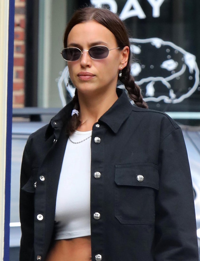 Braided pigtails, slim sunglasses, and Chrome Hearts detailing gave Irina Shayk's casual daytime look a distinctly '90s-inspired edge