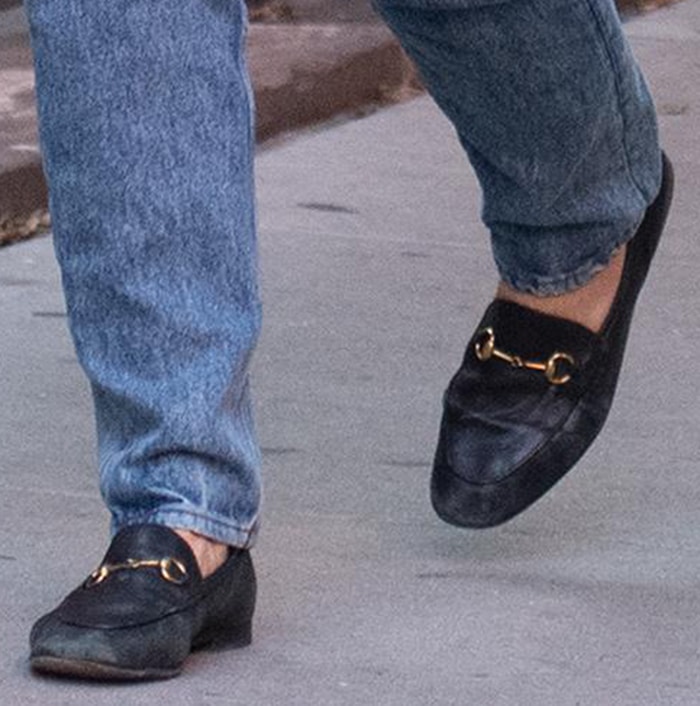 Katie Holmes grounds her fall look with black Gucci Jordaan horsebit loafers, the slim leather silhouette and signature gold hardware adding a polished finish to her relaxed straight-leg denim