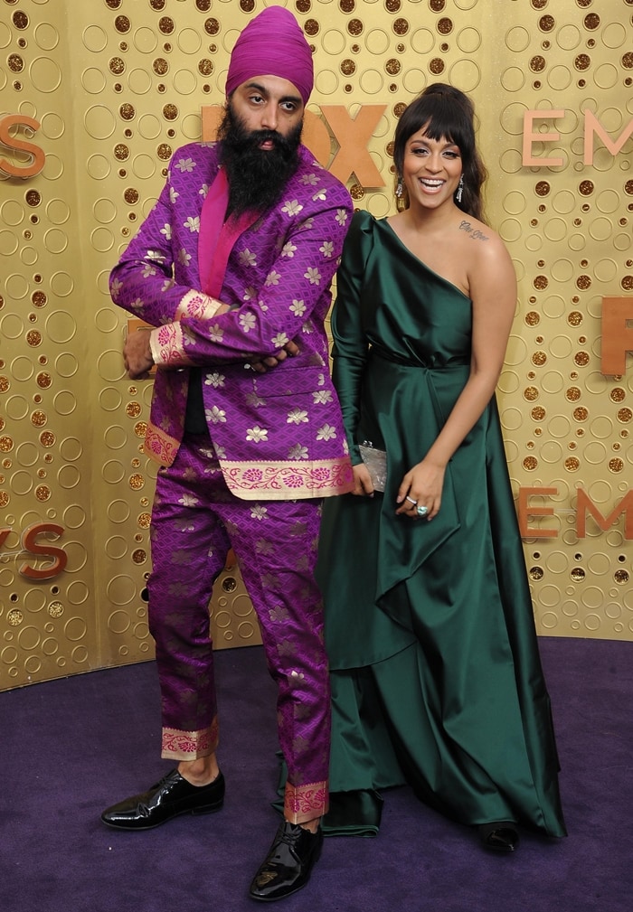 Lilly Singh and Humble The Poet bring bold style to the red carpet at the Emmy Awards, with Lilly in an elegant green one-shoulder gown and Humble in a vibrant purple traditional suit