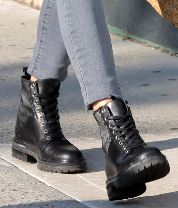 Olivia Palermo grounds her vibrant blue coat and distressed skinny jeans with Gianvito Rossi's Martis combat boots, a rugged lace-up style distinguished by ribbed stretch panels, chunky lug soles, and a modern military-inspired silhouette