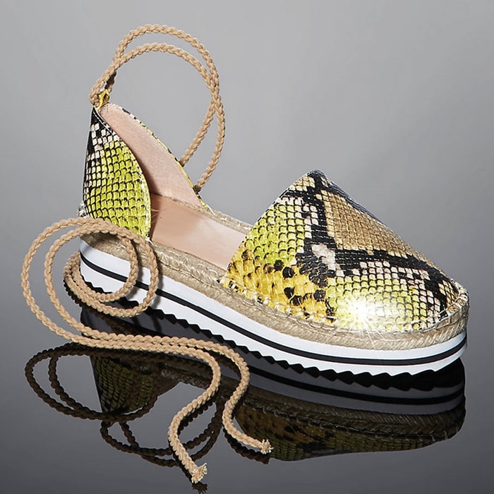 This design shows off a sporty, white-bottom sole with sawtooth treads and braided straps that wrap around the ankle