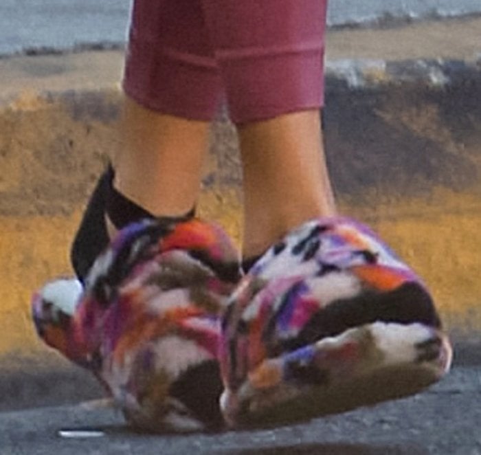 Chantel Jeffries completed her off-duty athleisure look with multicolored fuzzy Ugg Fluff Yeah slippers, adding a bold pop of texture and comfort to the sleek mauve leggings
