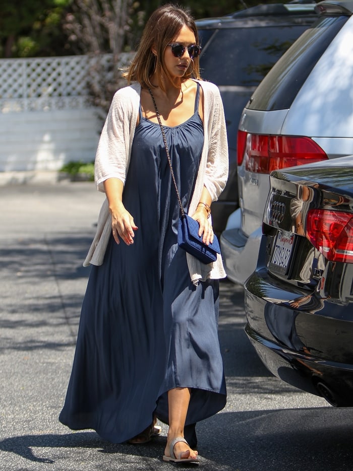 Jessica Alba styled Ariat's Copper Creek sandals with a flowing blue maxi dress and lightweight cardigan, showcasing the brand's move beyond boots into casual warm-weather footwear