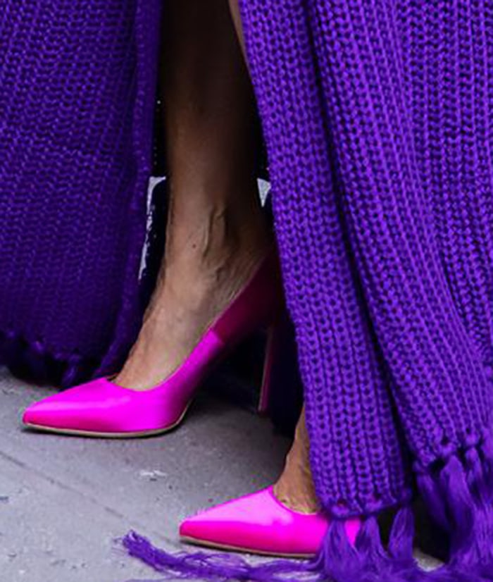 Sarah Jessica Parker pairs her purple Hanifa knit wrap dress with vibrant pink “Fawn” satin pumps from SJP by Sarah Jessica Parker