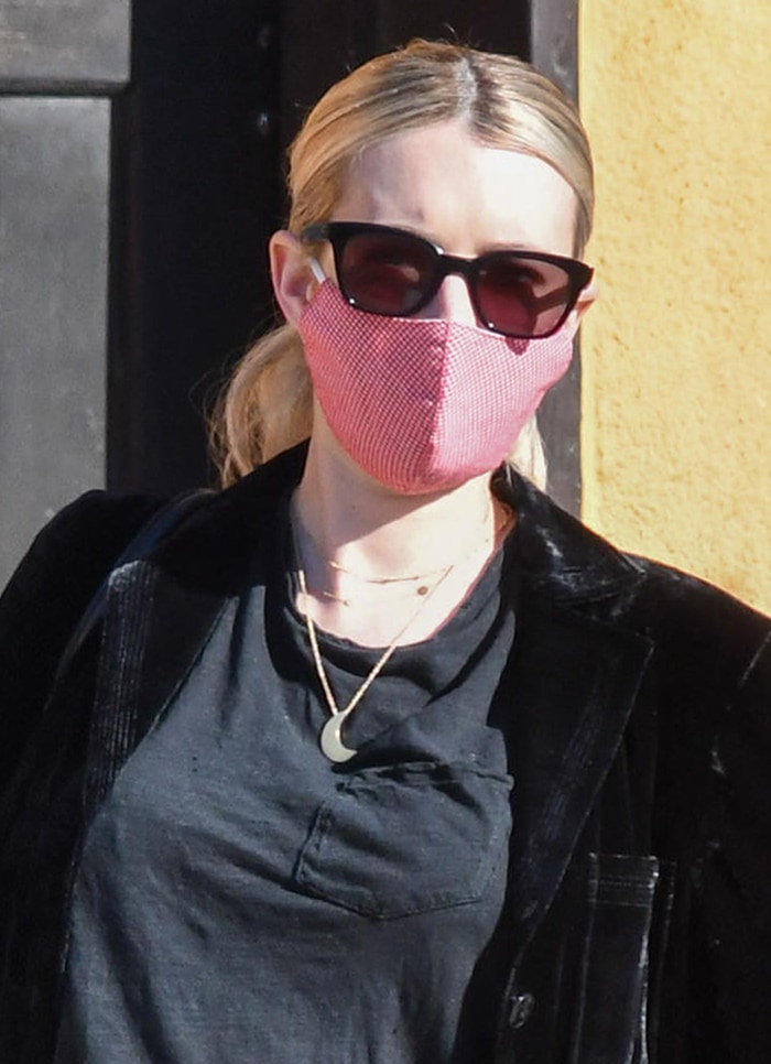 Emma Roberts wears Garrett Leight x Clare V. sunglasses, gold jewelry, and a red patterned face mask with her maternity outfit
