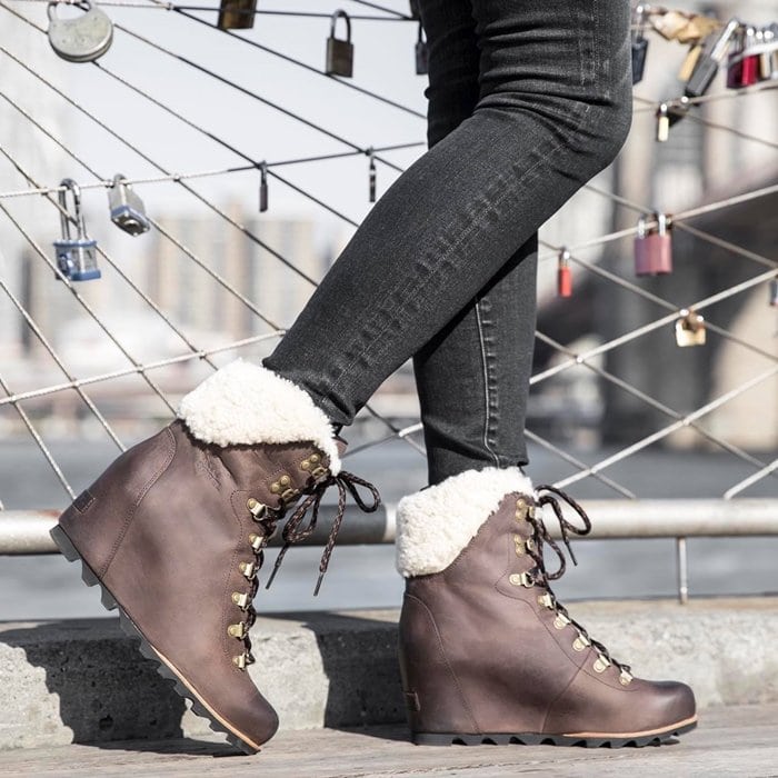 The SOREL Conquest Wedge Shearling boot pairs cozy fleece lining with a rugged lace-up design and hidden wedge heel for elevated cold-weather style