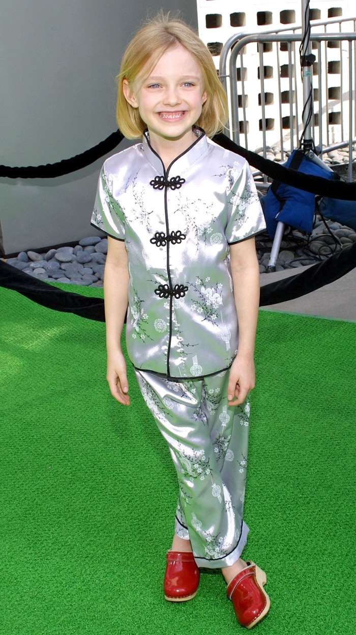 Dakota Fanning, who rose to prominence at just seven years old for her role as Lucy Dawson in I Am Sam (2001), charmed on the red carpet in a silk chinoiserie-inspired set paired with glossy red Mary Jane shoes