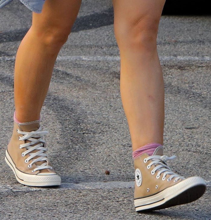 Switching to off-duty ease, Hilary Duff grounds her embellished mini dress with khaki Converse Chuck 70 high-tops, a high-low styling move that tempers sparkle with effortless streetwear cool