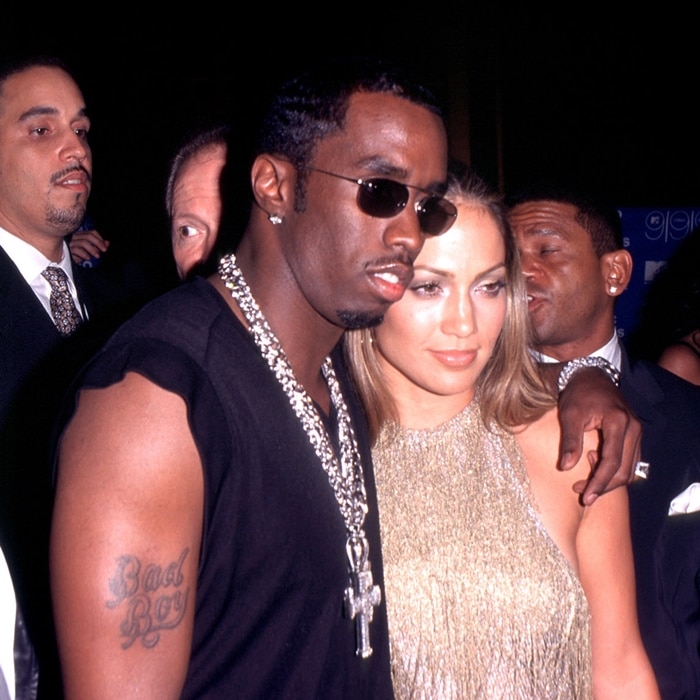 Jennifer Lopez turns heads in a shimmering gold halter dress while attending the 1999 MTV Video Music Awards with Sean "Puffy" Combs at the Metropolitan Opera House in NYC