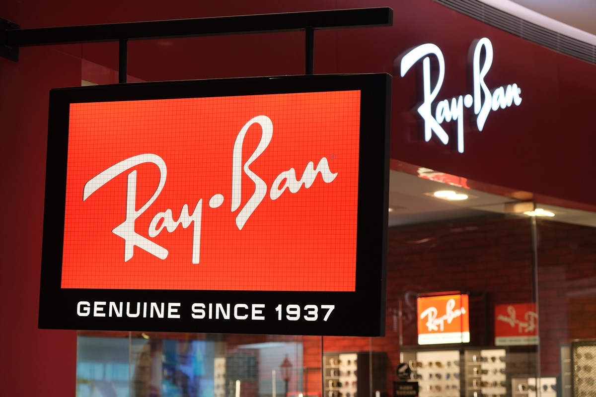 A glowing Ray-Ban storefront sign highlights the iconic eyewear brand’s legacy, proudly marked “Genuine Since 1937,” inside a modern retail setting