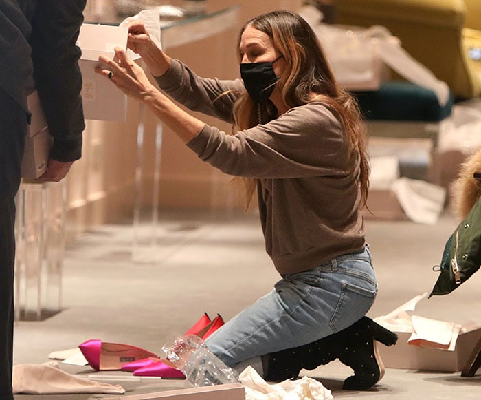 Sarah Jessica Parker wears her favorite gray top with cuffed jeans and SJP Busker knee boots