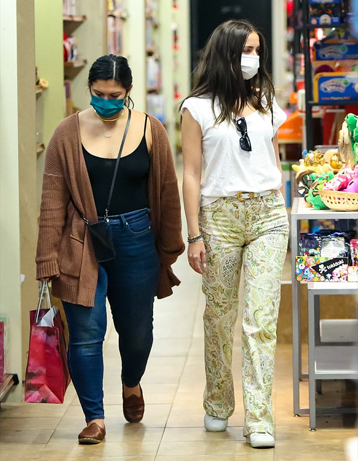 The low-profile Saint Laurent sneakers temper the bold print of Ana de Armas’ flared Etro jeans as she shops with a friend in Santa Monica