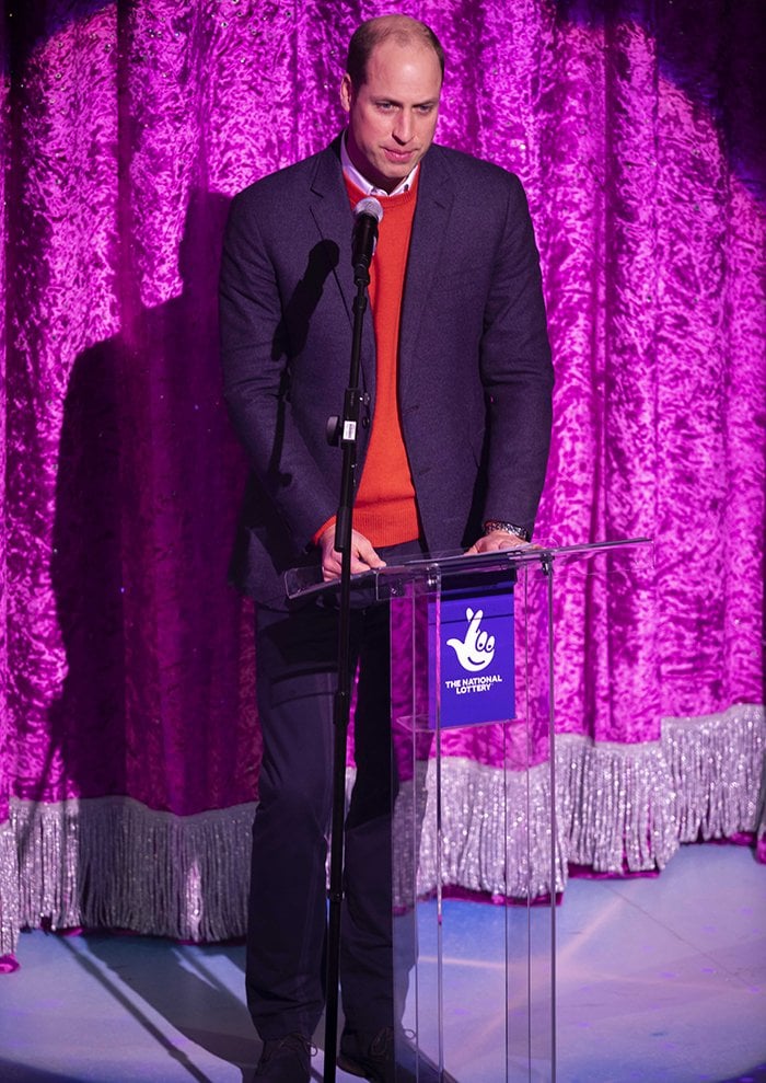 Prince William wears dark brown suede Chelsea boots with navy trousers as he addresses key workers before the Pantoland performance at The London Palladium