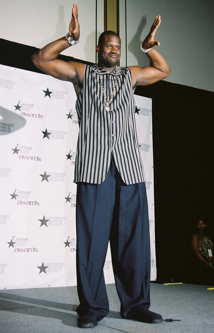 Shaquille O’Neal attends the 1st Annual BET Awards at the Paris Hotel in Las Vegas on June 19, 2001, wearing a bold striped sleeveless shirt and relaxed navy trousers that matched his larger-than-life personality