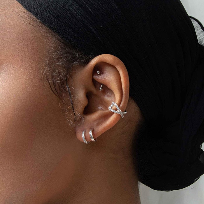 Illusion crystal silver stud earrings have the appearance of two earrings in only one piercing