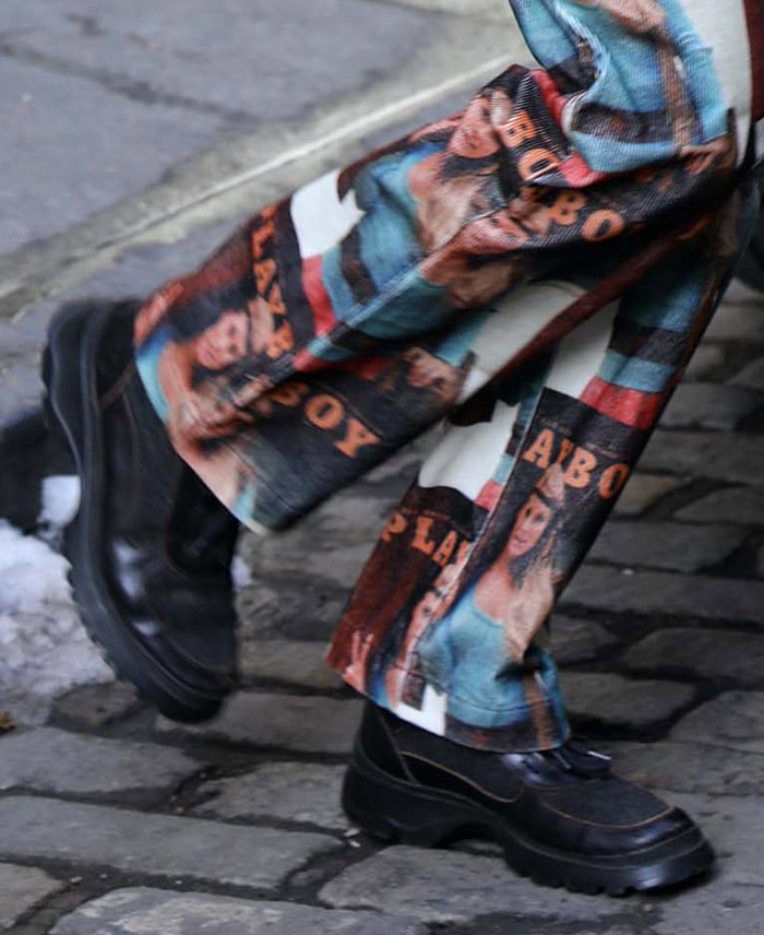 A close-up of Bella Hadid’s look reveals her chunky black leather-and-suede sneakers, complete with thick lug soles for a distinctly ’90s edge