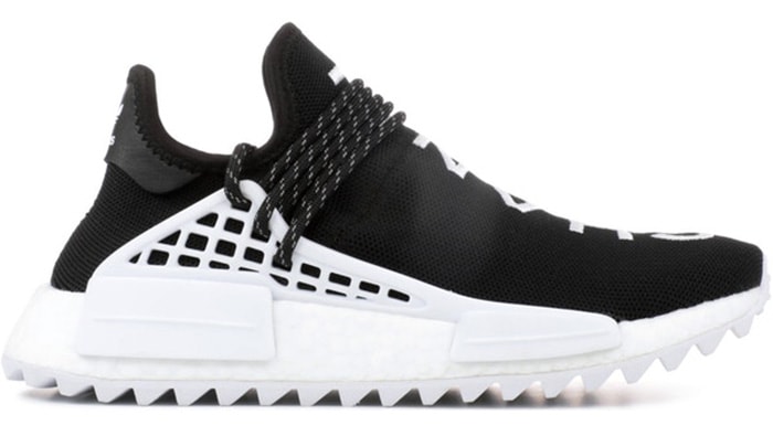 The Chanel x Pharrell x Adidas NMD Hu, released in 2017 with just 500 pairs, combines minimalist black-and-white design with bold branding, making it one of the rarest NMD collaborations and valued at over $10,000 on the resale market
