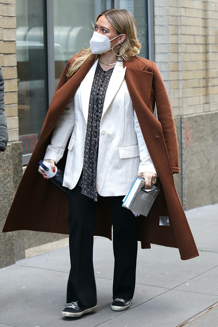 Hilary Duff trades her animal-print outfit for a white blazer with a printed blouse underneath