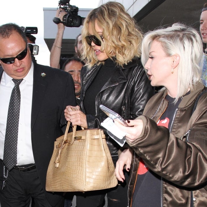 Khloé Kardashian adds a touch of luxury to her travel look with a rare beige crocodile Hermès Birkin bag