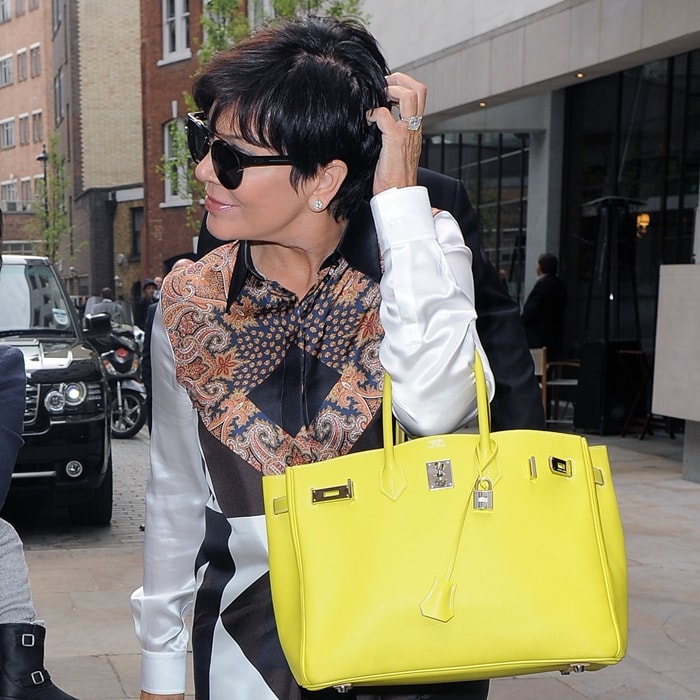 Kris Jenner carries a bright yellow Hermès Birkin bag