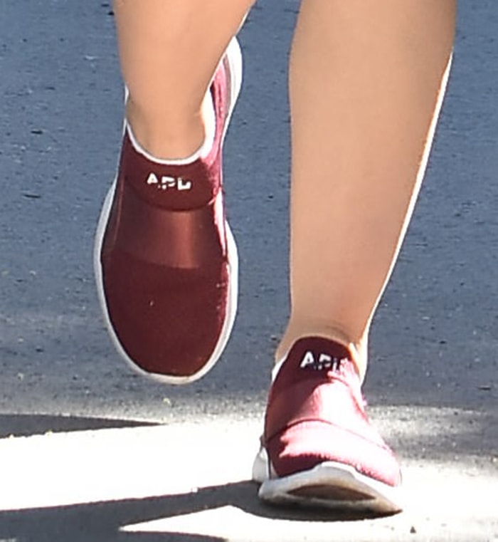 Lucy Hale showcases effortless style in a pair of burgundy APL TechLoom Bliss sneakers