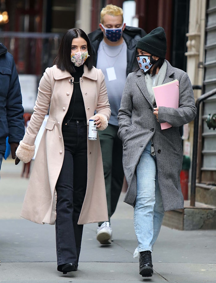 The long flared coat and bootcut denim create a noticeably sharper silhouette than Hale’s Los Angeles leggings-and-sneakers combinations