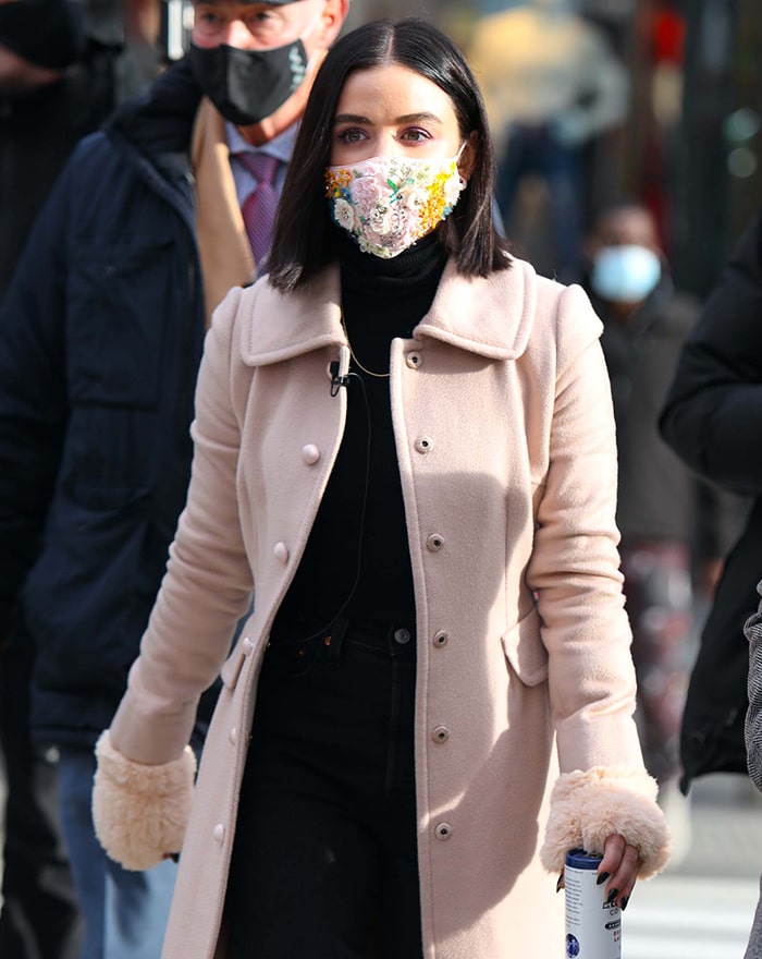 An embroidered floral Jennifer Behr face mask adds color and texture to Hale’s neutral Dolce Gabbana outerwear