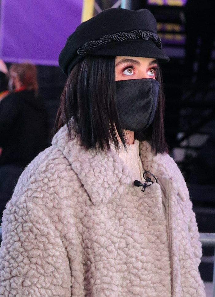 A black Ruslan Baginskiy baker boy cap and matching face mask complete Hale’s texture-heavy winter combination of teddy fleece and leather
