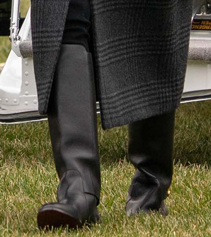 Melania Trump steps out in black calfskin leather Dior Empreinte riding boots beneath a tailored plaid coat