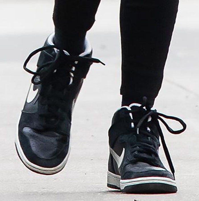 A close-up of Nicky Hilton's black-and-white Nike SB Dunk High sneakers highlights the timeless colorway that continues to pair effortlessly with everything from denim to bold winter coats
