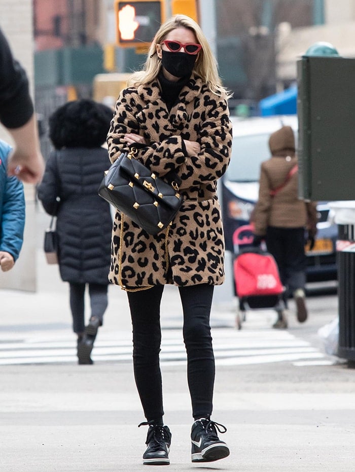 Nicky Hilton pairs an Apparis leopard-print faux-fur coat with black-and-white Nike SB Dunk High sneakers, proving statement outerwear works just as well with classic skate shoes as it does with boots